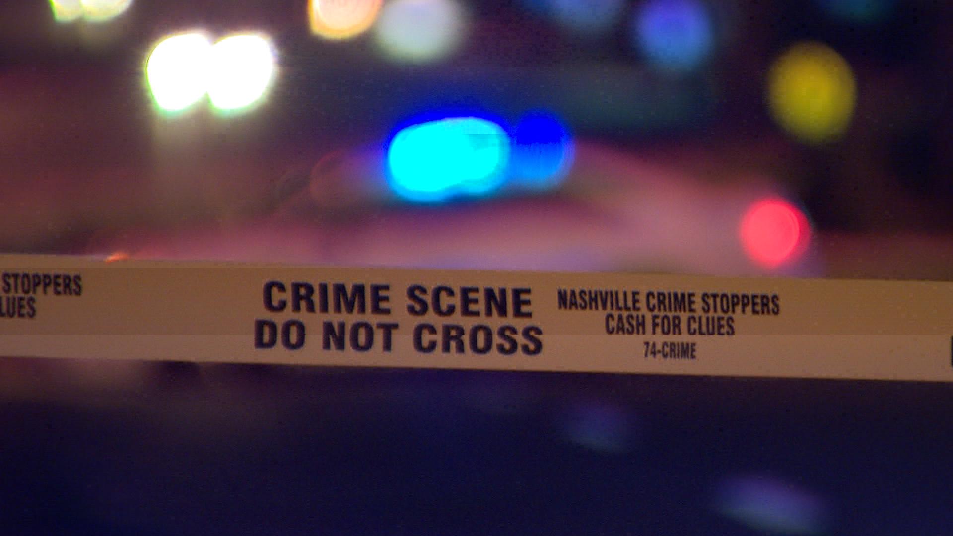 crime scene tape metro police car blurry.jpg