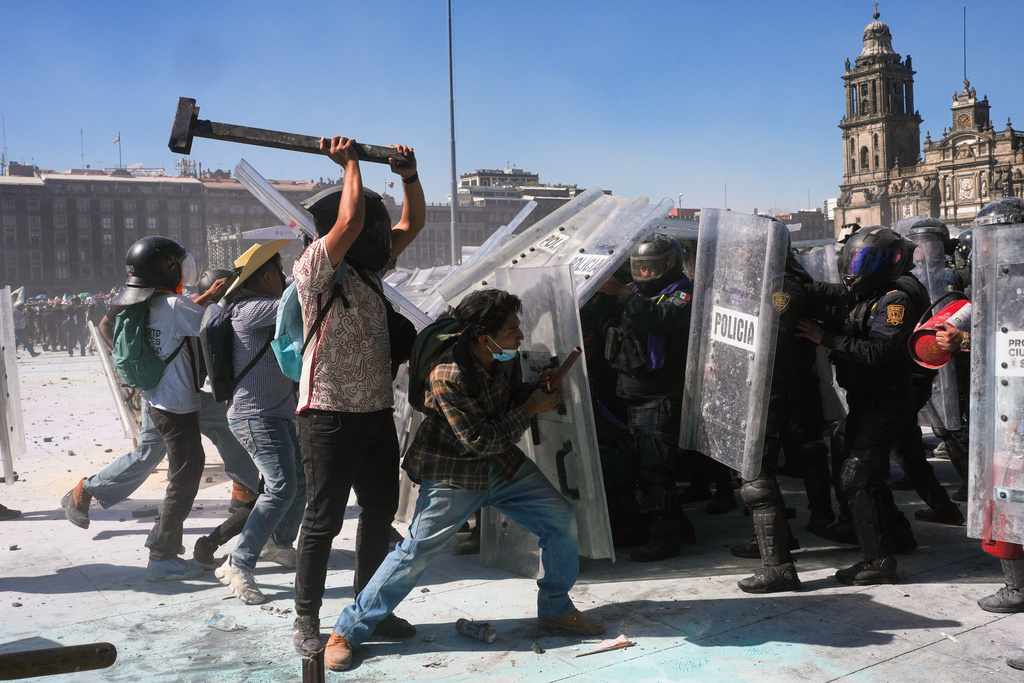 Protesters charge at police during a youth anti-government march in Mexico City, Saturday, Nov. 15, 2025. 