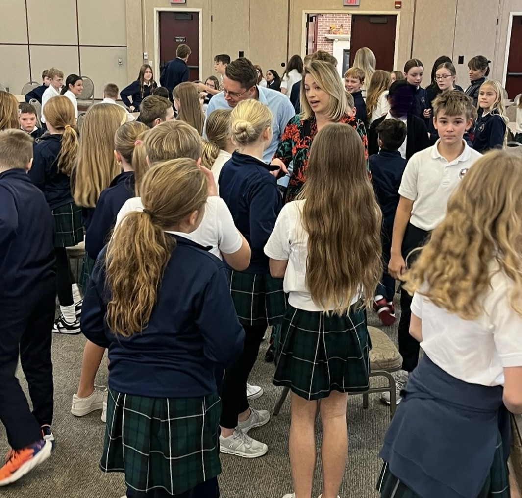 Mark Stitz and Mary Nelson connect with students at St. Robert's in Omaha.