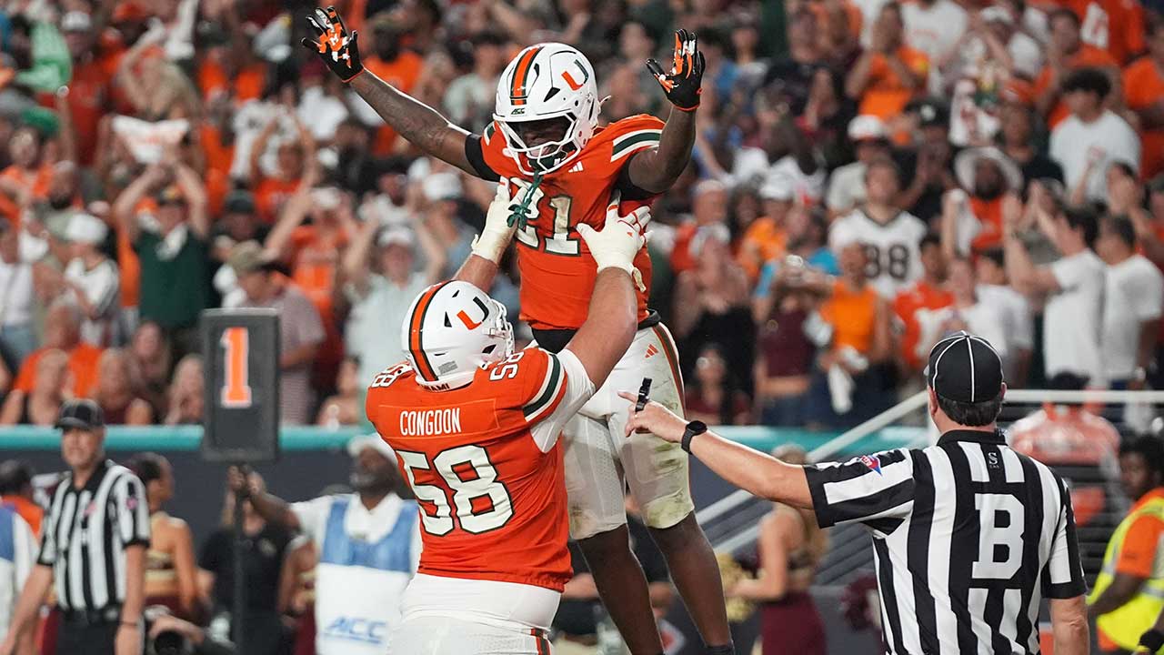 Miami running back Javian Mallory (21) celebrates with offensive lineman Ben Congdon (58) after scoring a touchdown during the second half of an NCAA college football game against Florida State, Saturday, Oct. 17, 2026, in Miami Gardens, Fla. (AP Photo/Lynne Sladky)