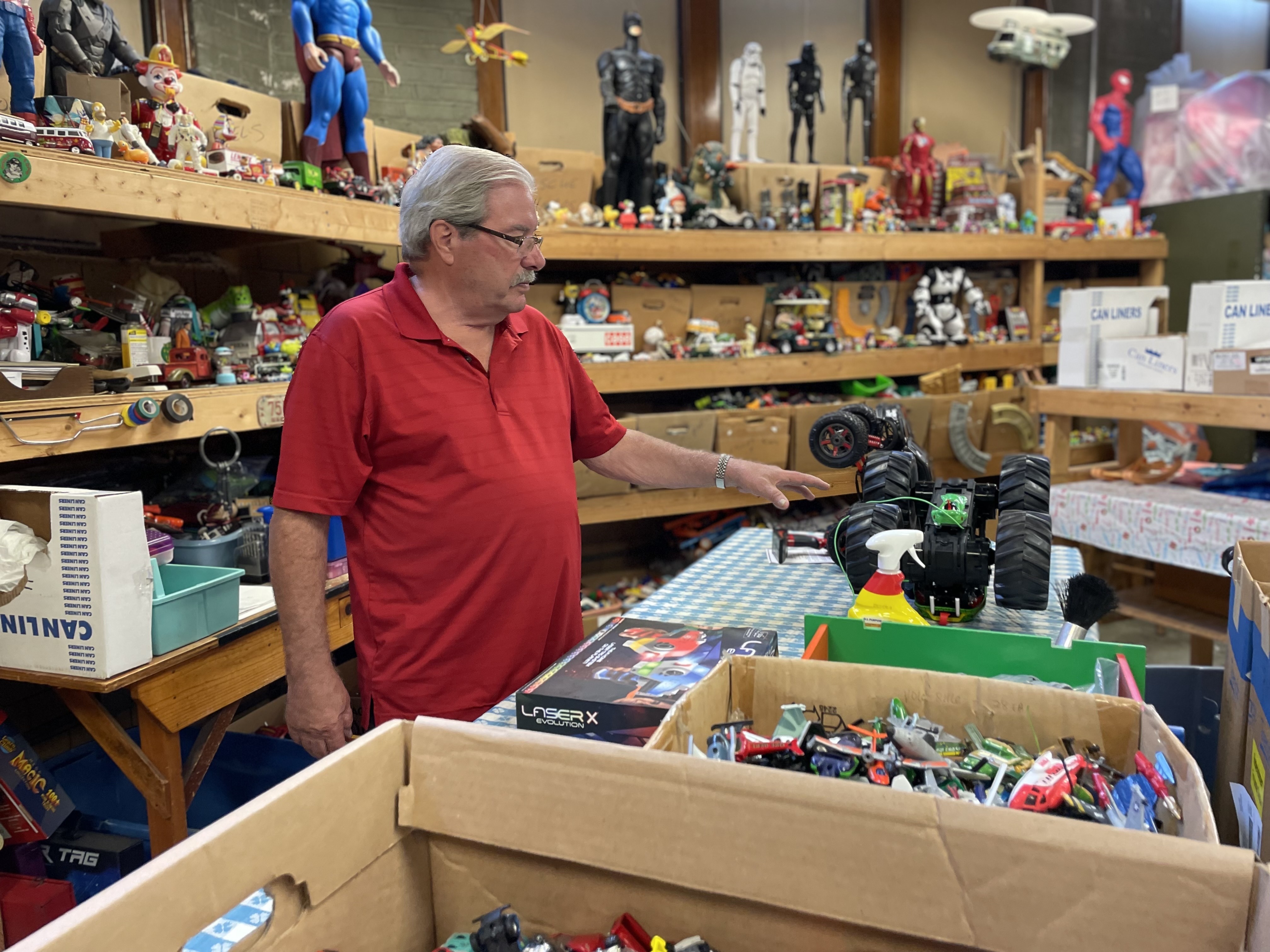 Pete Waselchuck at workshop surrounded by dozens of toys