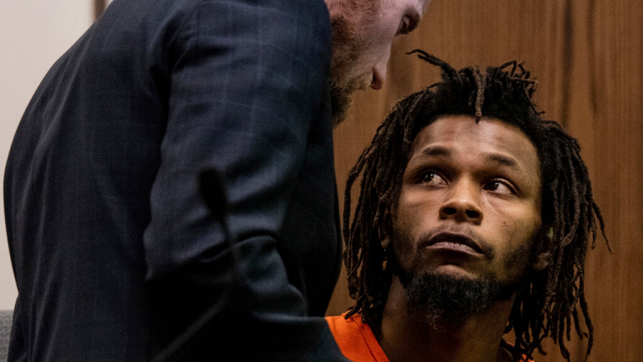 Nicholas Jordan, 25, speaks with his legal counsel