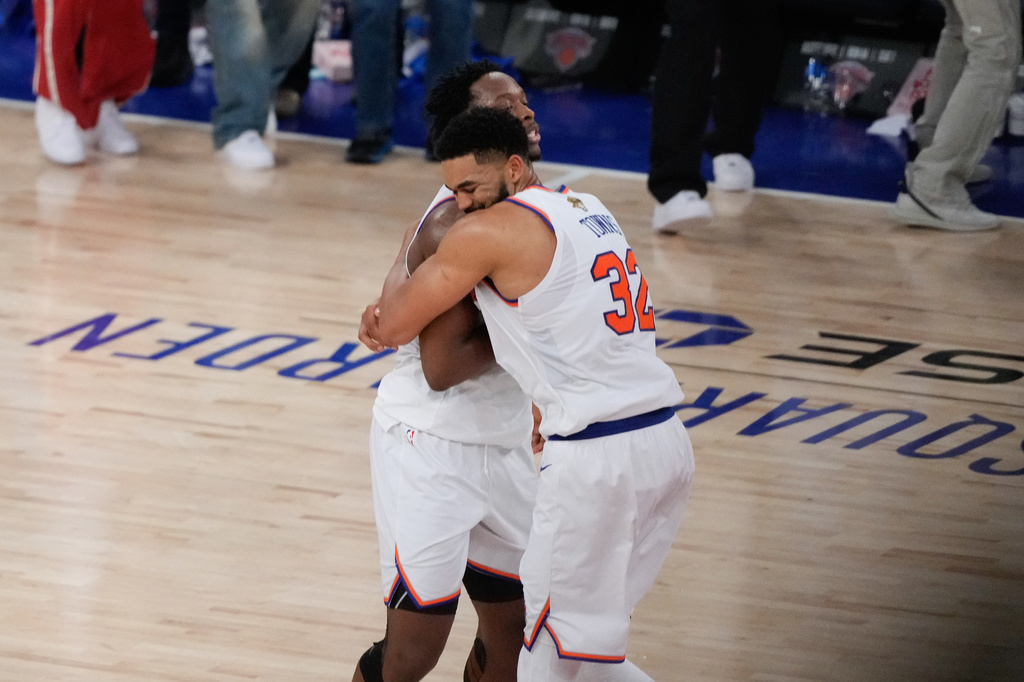 New York Knicks center Karl-Anthony Towns (32) embraces forward Og Anunoby after Game 4 of the NBA Finals basketball series against the San Antonio Spurs, Wednesday, June 10, 2026, in New York. 