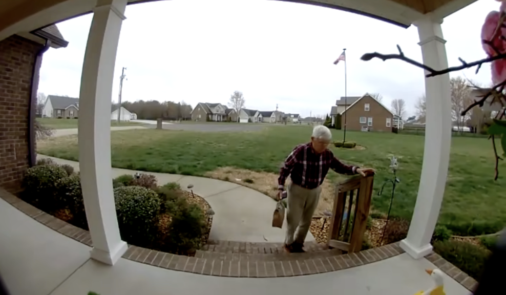 An elderly man delivers a DoorDash order. 
