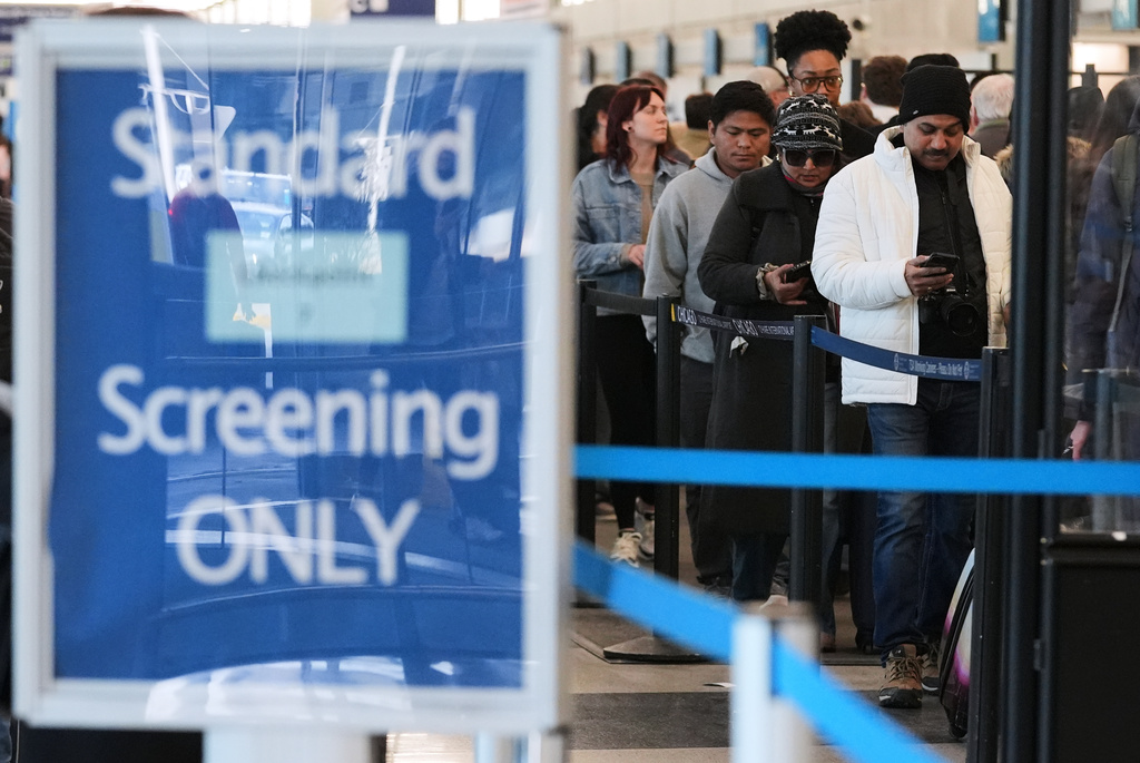 Travelers line up at a TSA checkpoint at O'Hare International Airport in Chicago, Tuesday, March 24, 2026.