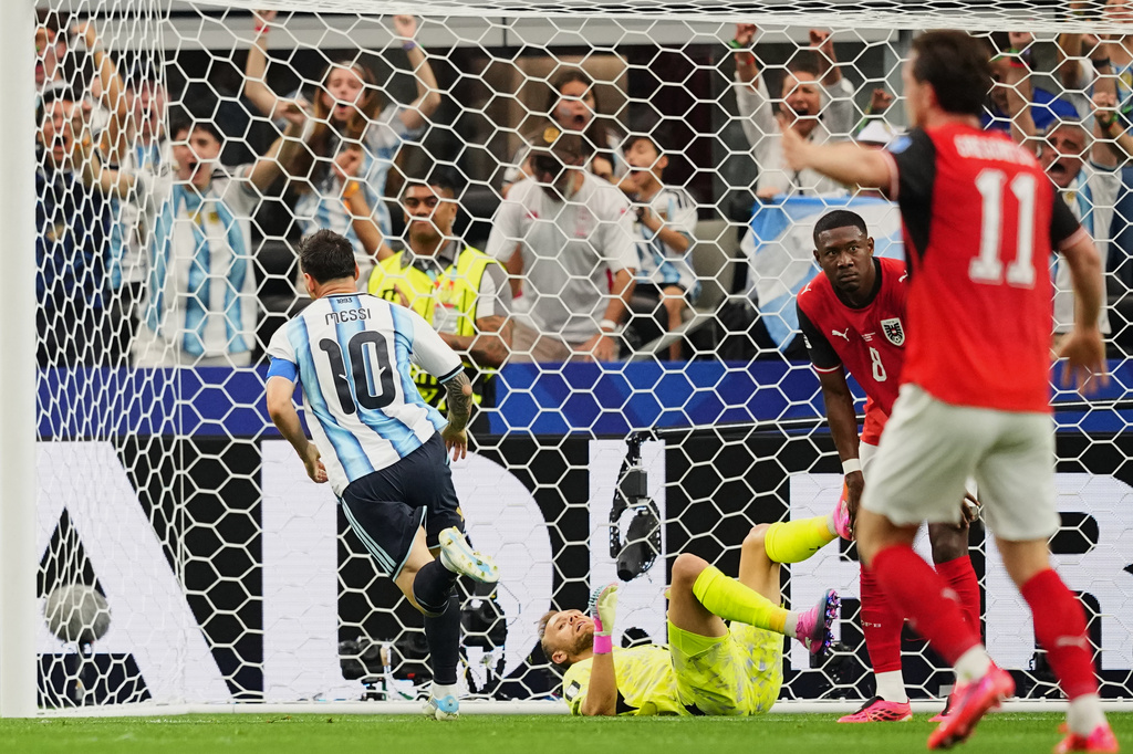 Argentina's Lionel Messi, left, runs celebrating after scoring the opening goal during the World Cup Group J soccer match between Argentina and Austria in Arlington, Texas, near Dallas, Monday, June 22, 2026. 