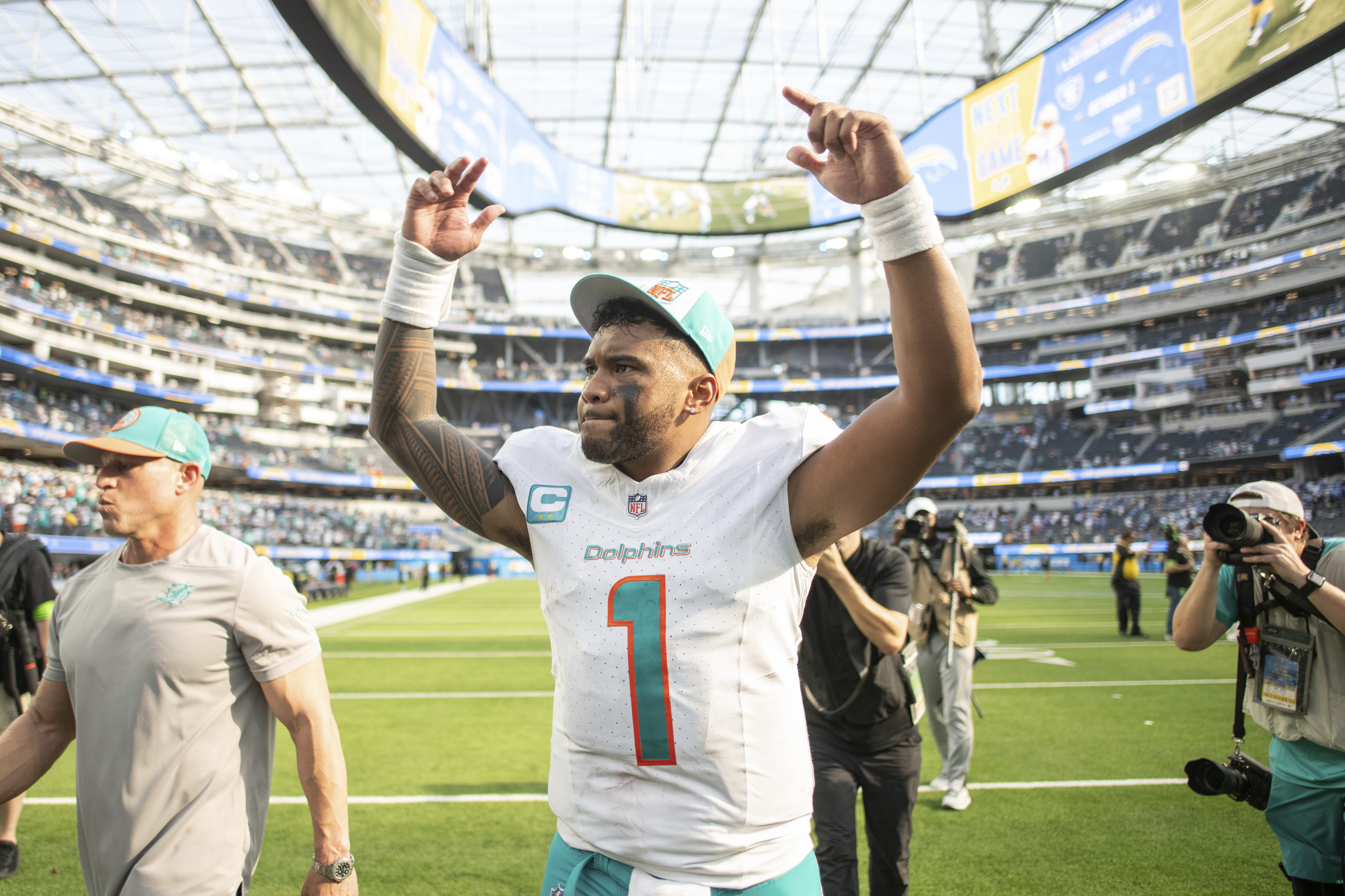 Miami Dolphins QB Tua Tagovailoa raises arms into air after win at Los Angeles Chargers, Sept. 10, 2023