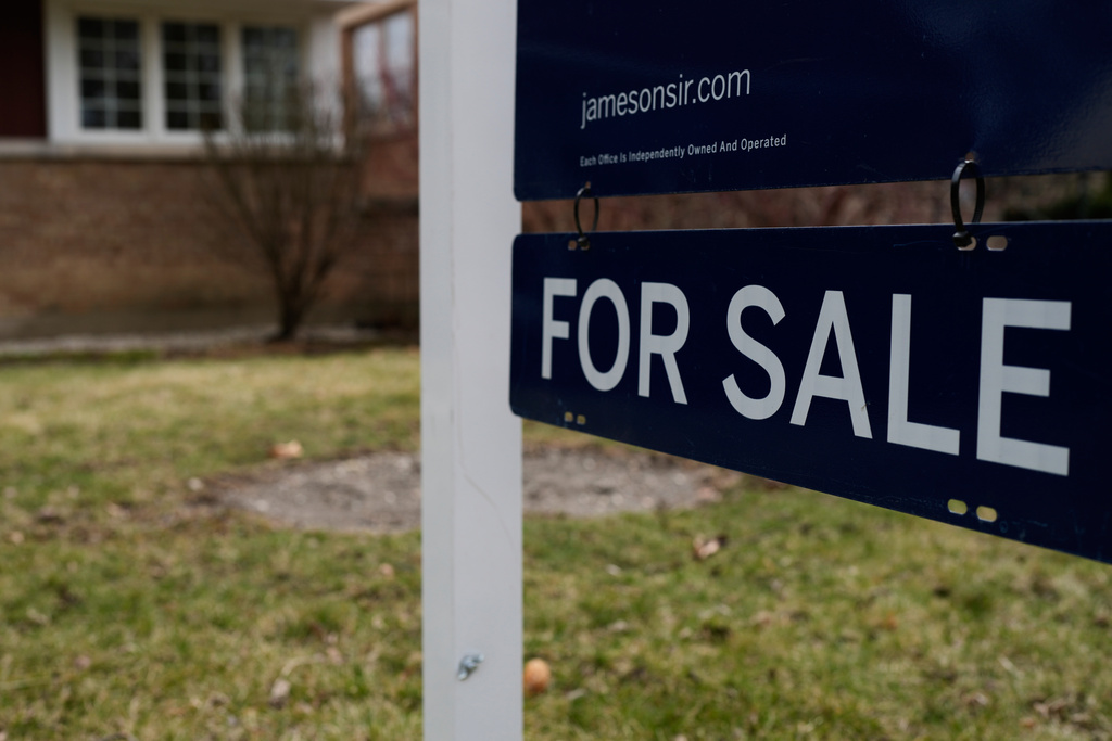 A House For Sale sign is displayed in front of a home in Evanston, Ill.,Wednesday, March 25, 2026.