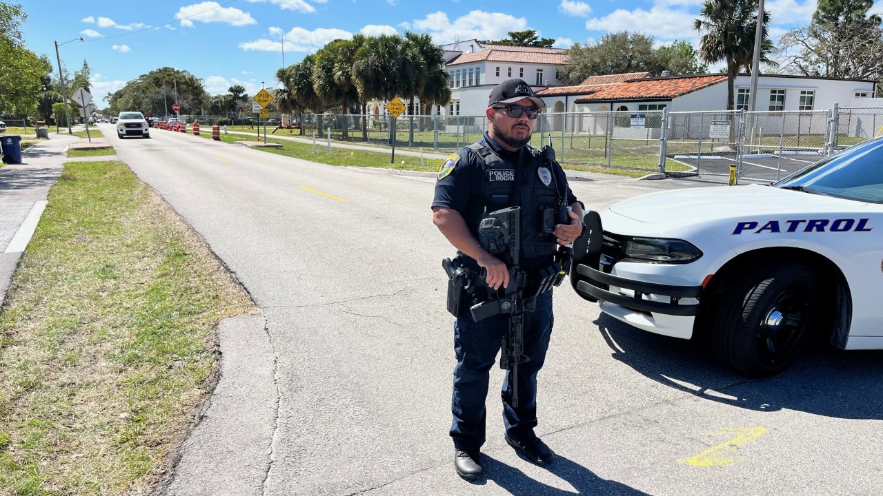 Jupiter police officer holds gun outside lockdown at Jupiter Elementary School, Feb. 15, 2023
