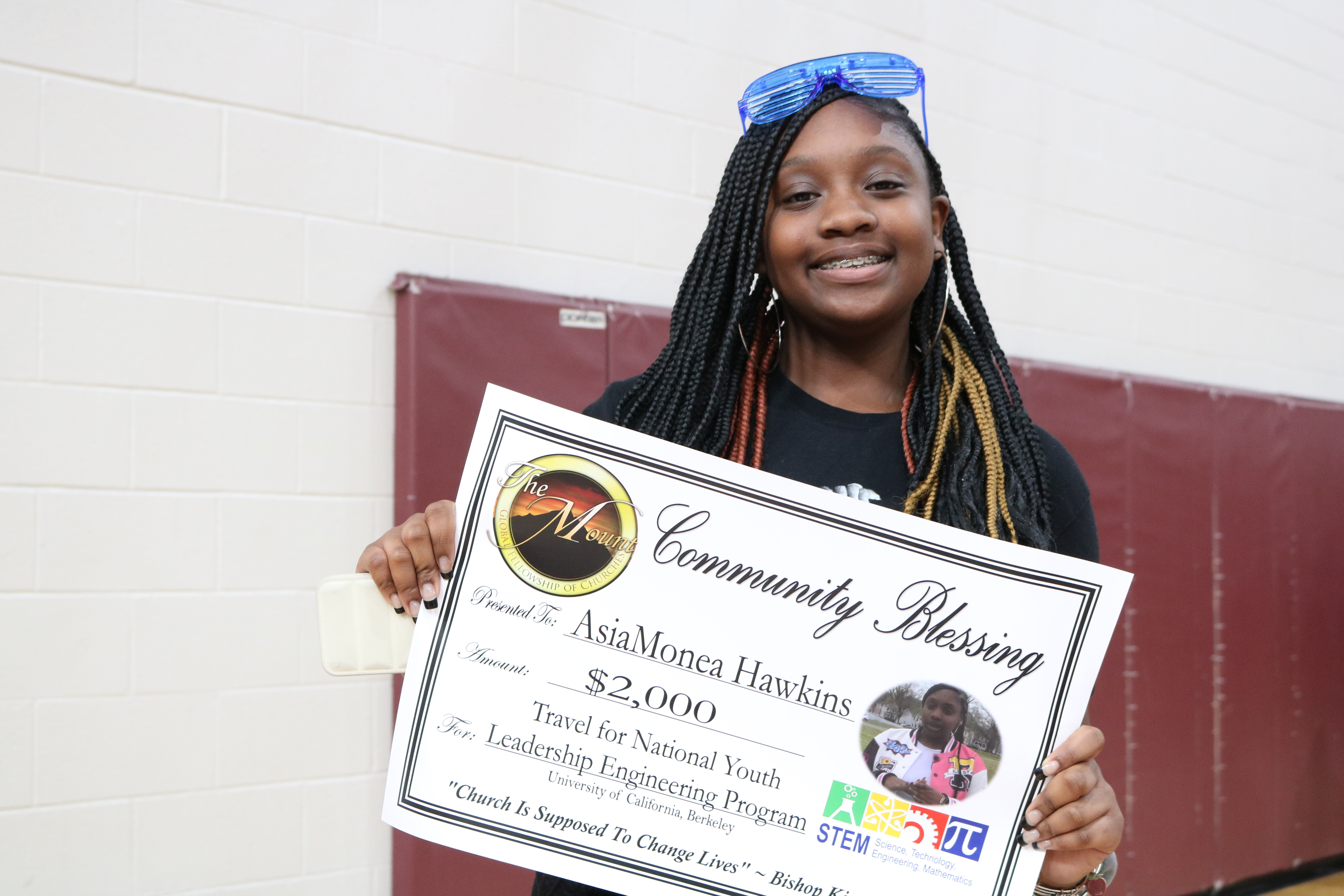 AsiaMonae Hawkins receives a donation from a local church.
