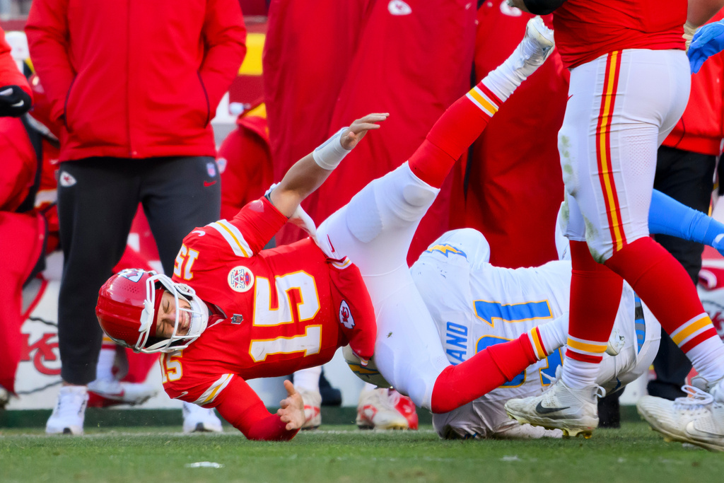 Kansas City Chiefs quarterback Patrick Mahomes (15) is injured after being tackled by Los Angeles Chargers defensive tackle Da'Shawn Hand (91) during the second half of an NFL football game, Sunday, Dec. 14, 2025 in Kansas City, Mo. 