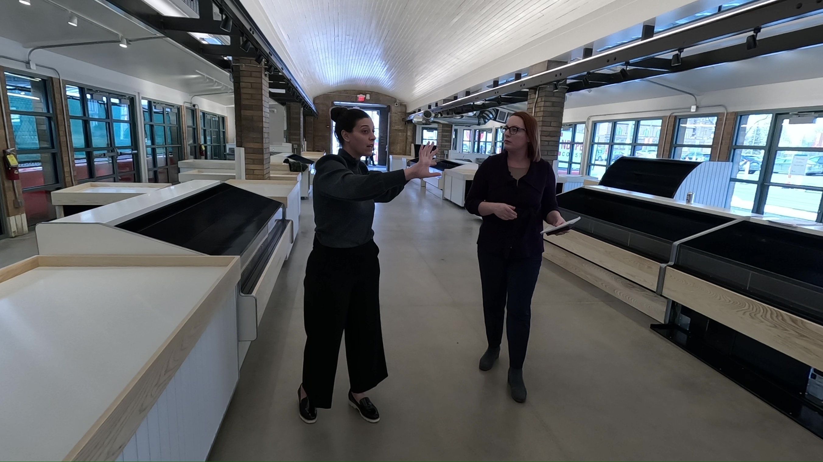 Rosemary Mudry, left, the executive director of the Cleveland Public Market Corporation, gives New 5 reporter Michelle Jarboe a preview tour of the revamped produce arcade.