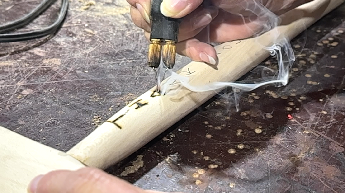 Volunteer Lisa Hutchins burns 'Thank You For Your Service' into a cane.