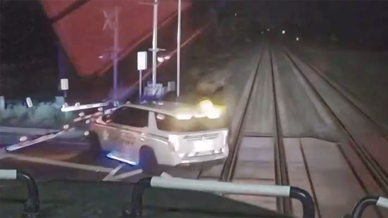Video provided by the Martin County Sheriff's Office shows a deputy stopped on the tracks with the gates closed before it was hit by a train on Feb. 17, 2025.