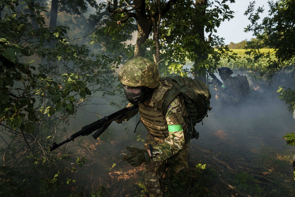 A Ukrainian National Guard serviceman of 3rd brigade runs through a tree line during a training not far from the frontline on Pokrovsk direction, Ukraine.