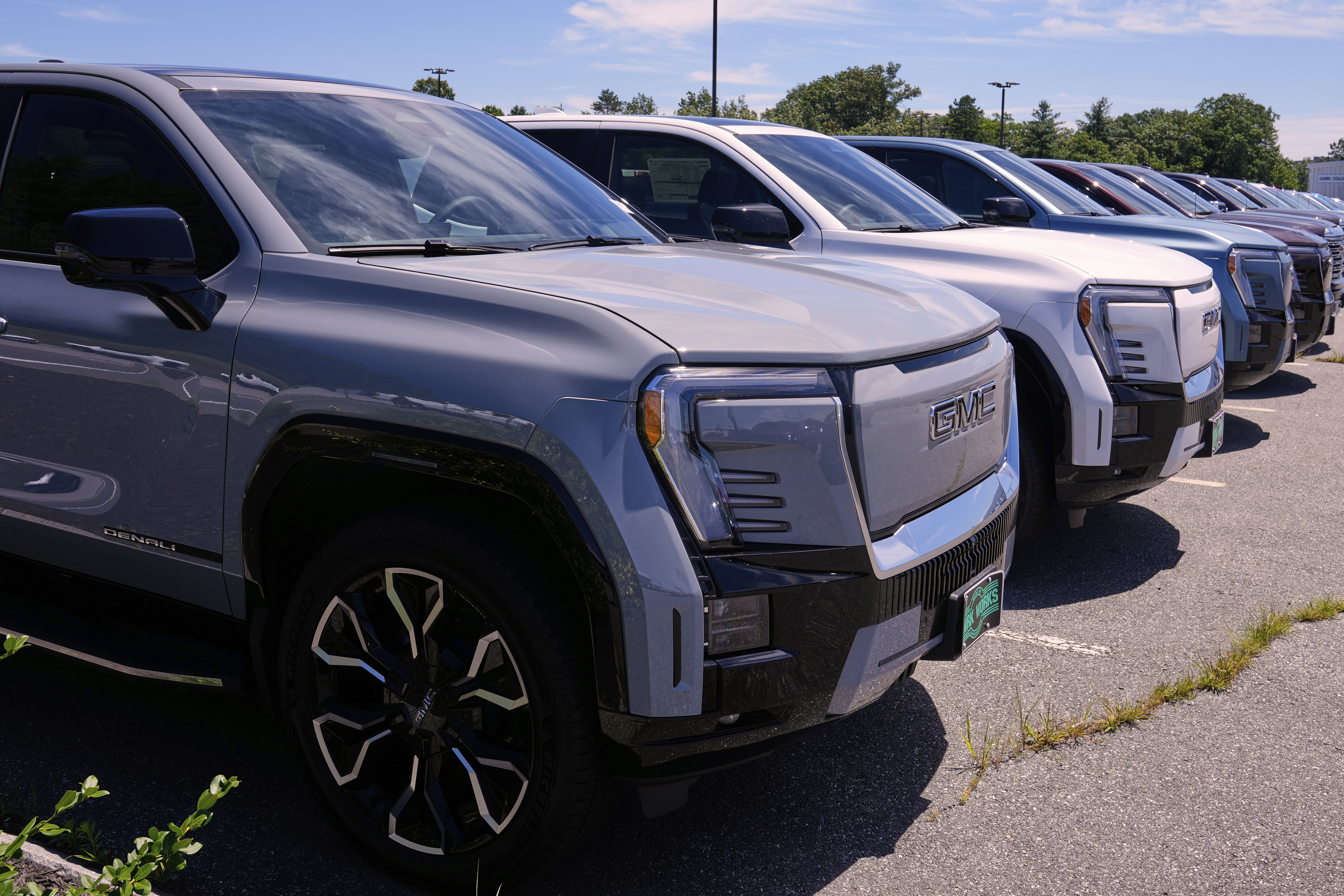 A selection of 2025 GMC Sierra EV Denali pick-up trucks, which are fully electric vehicles, are displayed at a GMC/Hummer truck dealership, Friday, July 18, 2025, in Manchester, N.H. 