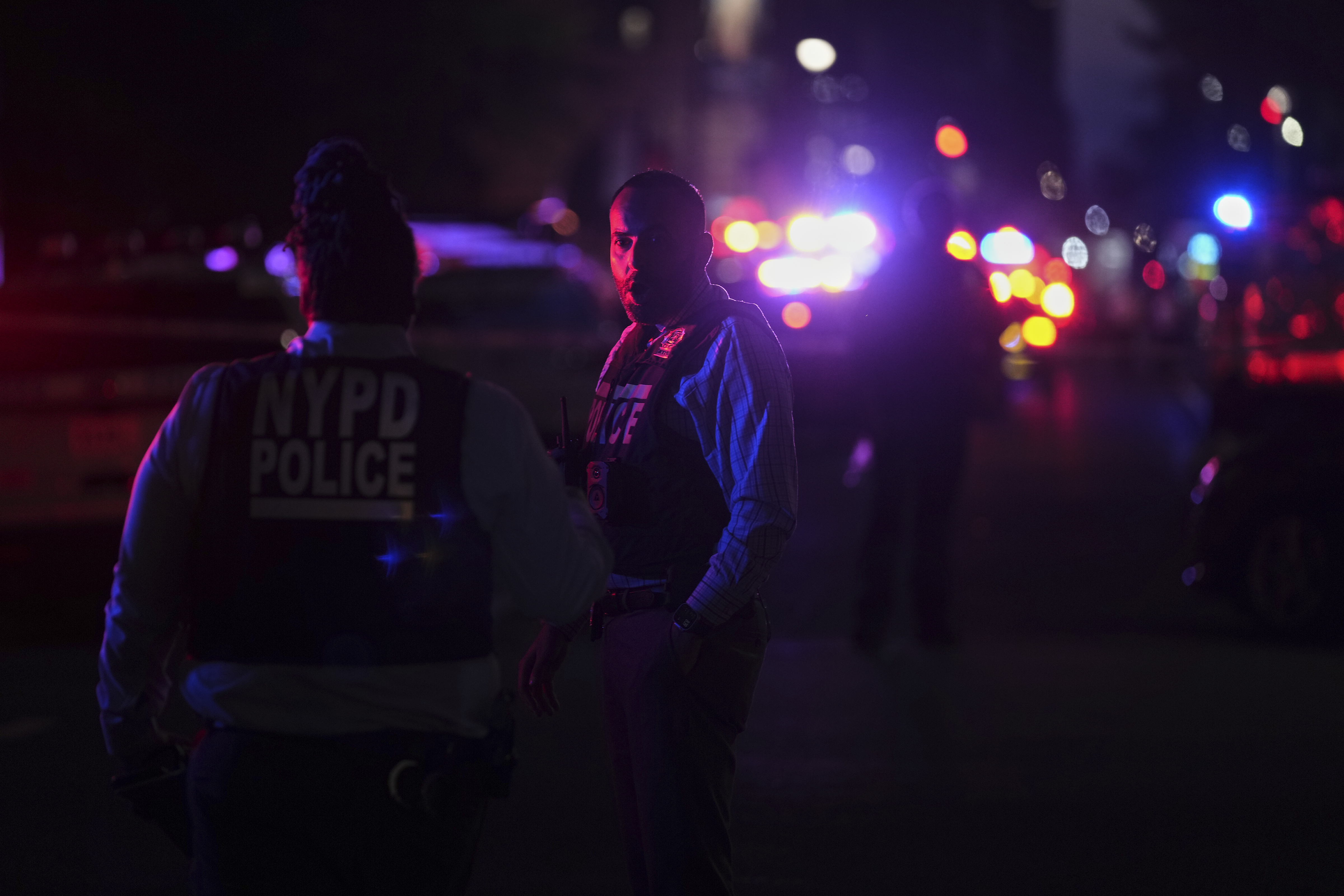 New York Police officers gather at the scene on 52nd Street outside a Manhattan office building where two people were shot, including a New York police officer, Monday, July 28, 2025, in New York. 