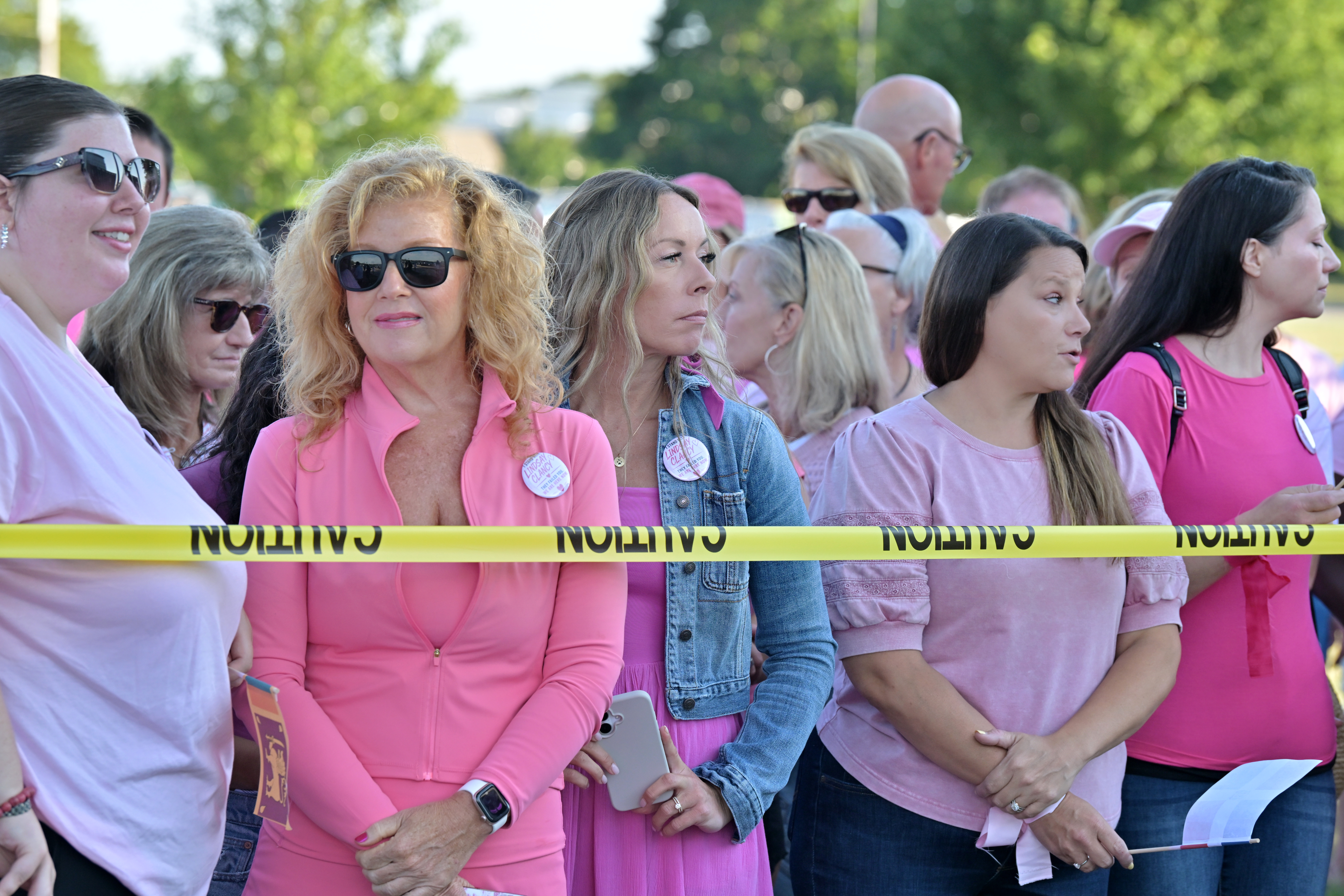 Women in pink rally in support of Lindsay Clancy, who is on trial for killing 3 children