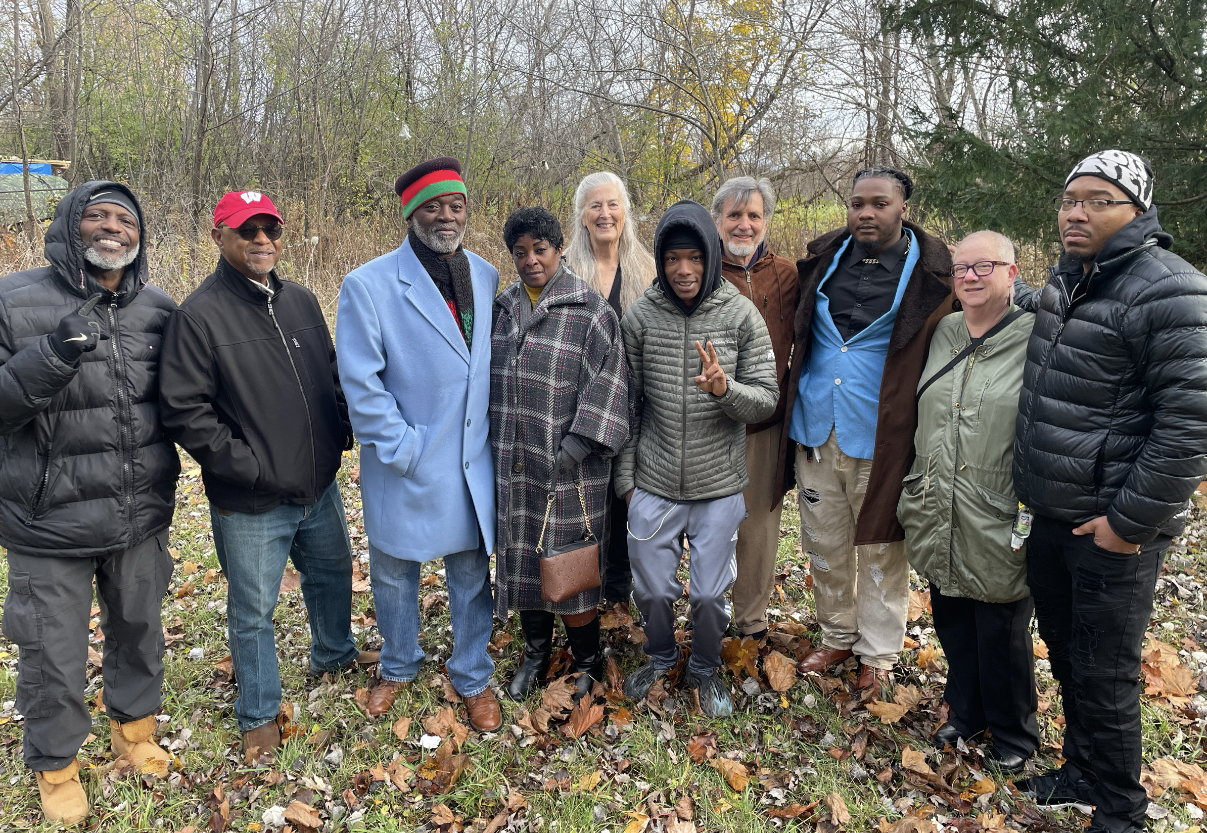 Developers, residents and community members gather for a group phot at the land for the new co housing devenlopment and garden