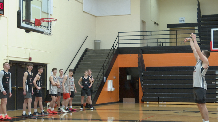 Hank Smith shoots free throw at practice while teammates look on, Frenchtown High School, Tuesday, March 4 2026