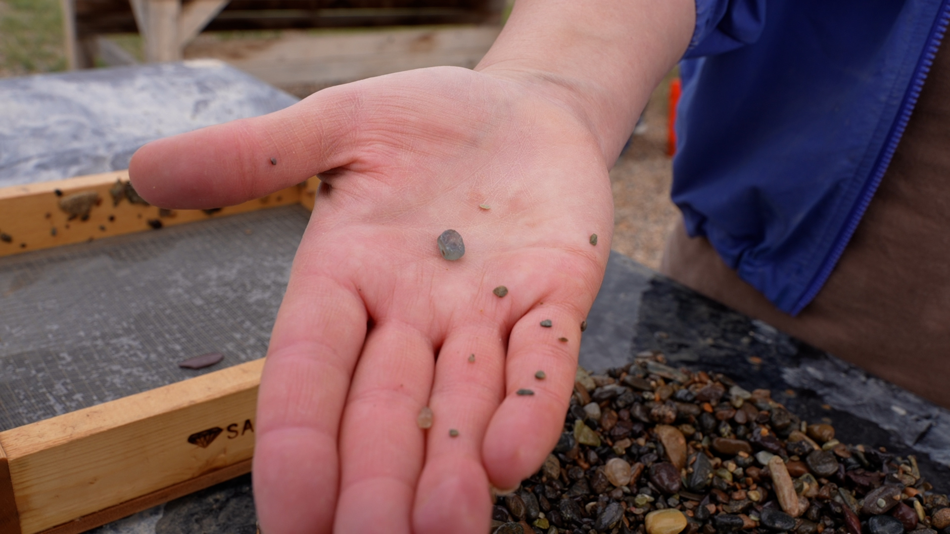 Hand holding sapphire 