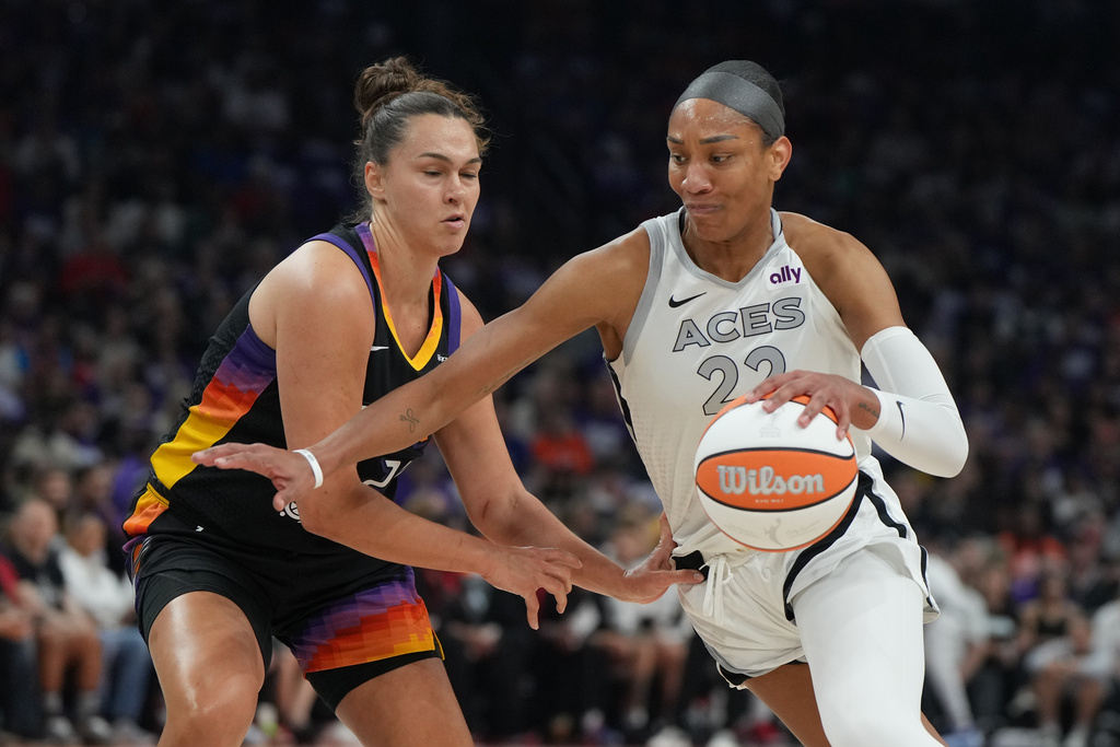 Las Vegas Aces center A'ja Wilson (22) drives on Phoenix Mercury forward Kathryn Westbeld (24) during the first half of Game 4 of the WNBA basketball finals, Friday, Oct. 10, 2025, in Phoenix. 