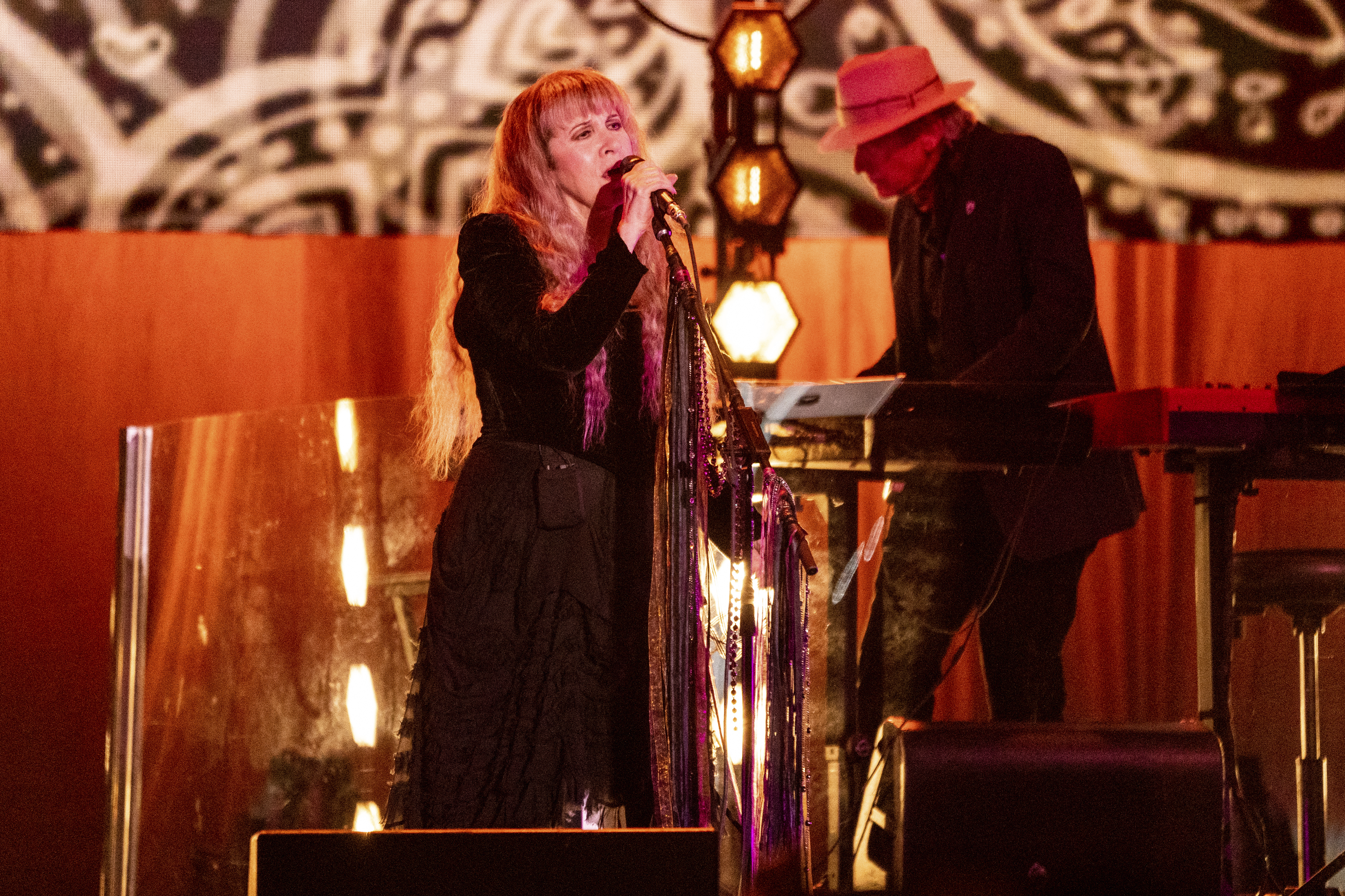 Stevie Nicks holds micophone during performance at Bonnaroo Music and Arts Festival, June 19, 2022