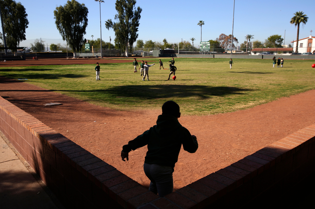 Students play ball during recess at the St. Agnes Elementary School in Phoenix, Ariz., on March 3, 2020. 