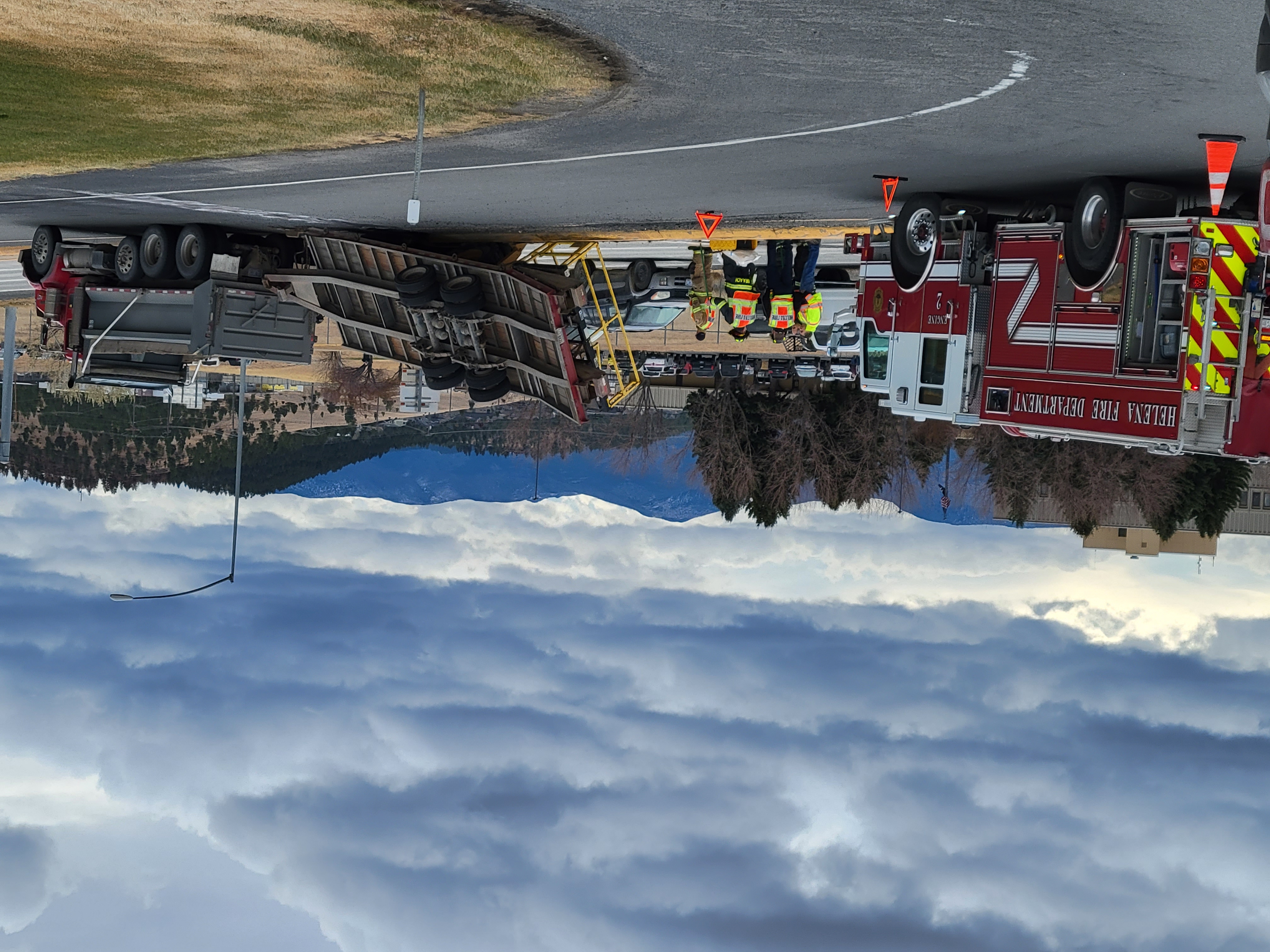 Crews work to clear overturned trailer with heavy machinery on prostpect/I-15 on-ramp