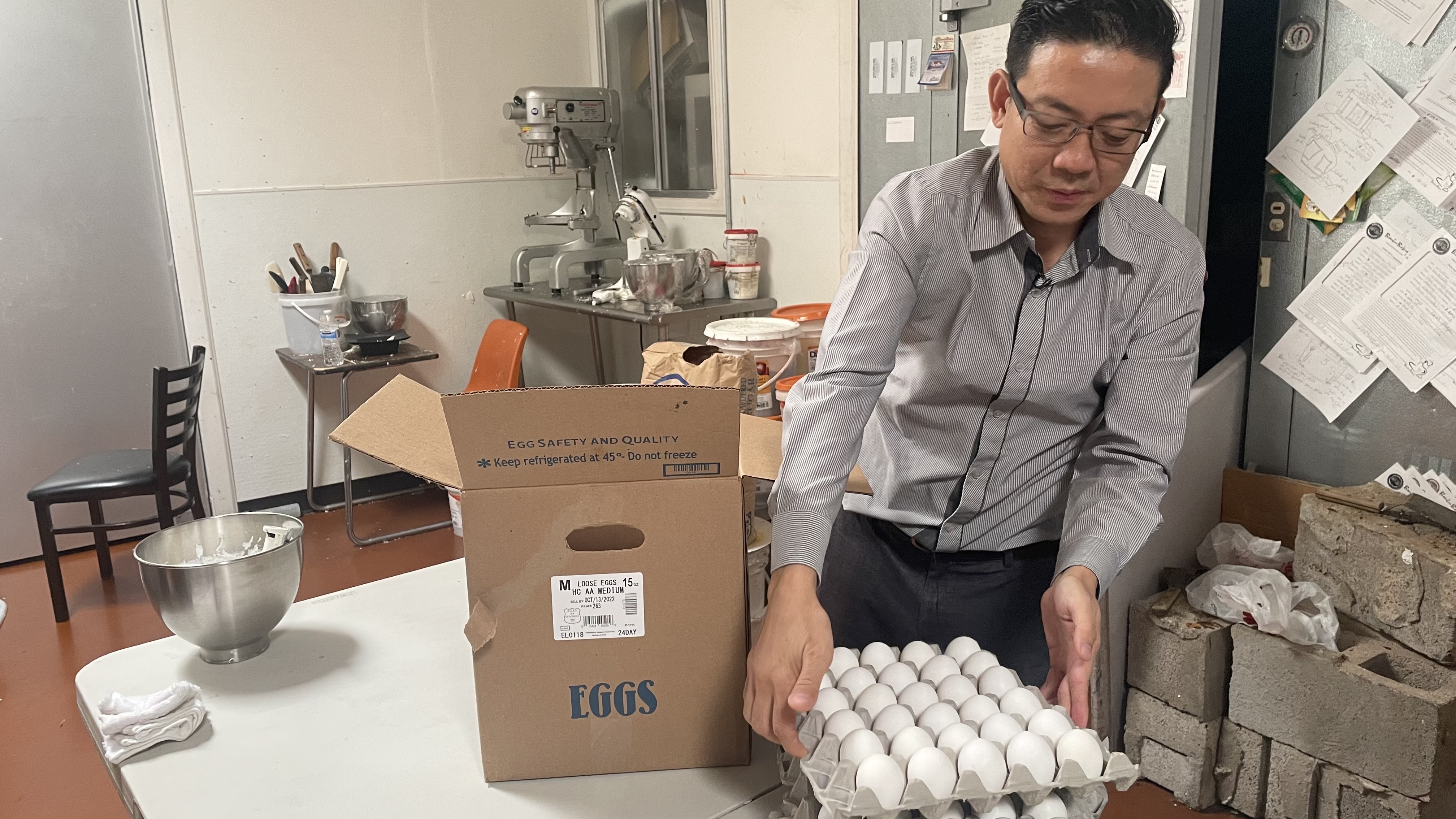 David Pham taking out eggs at his business Bamboo Bakery.jpeg