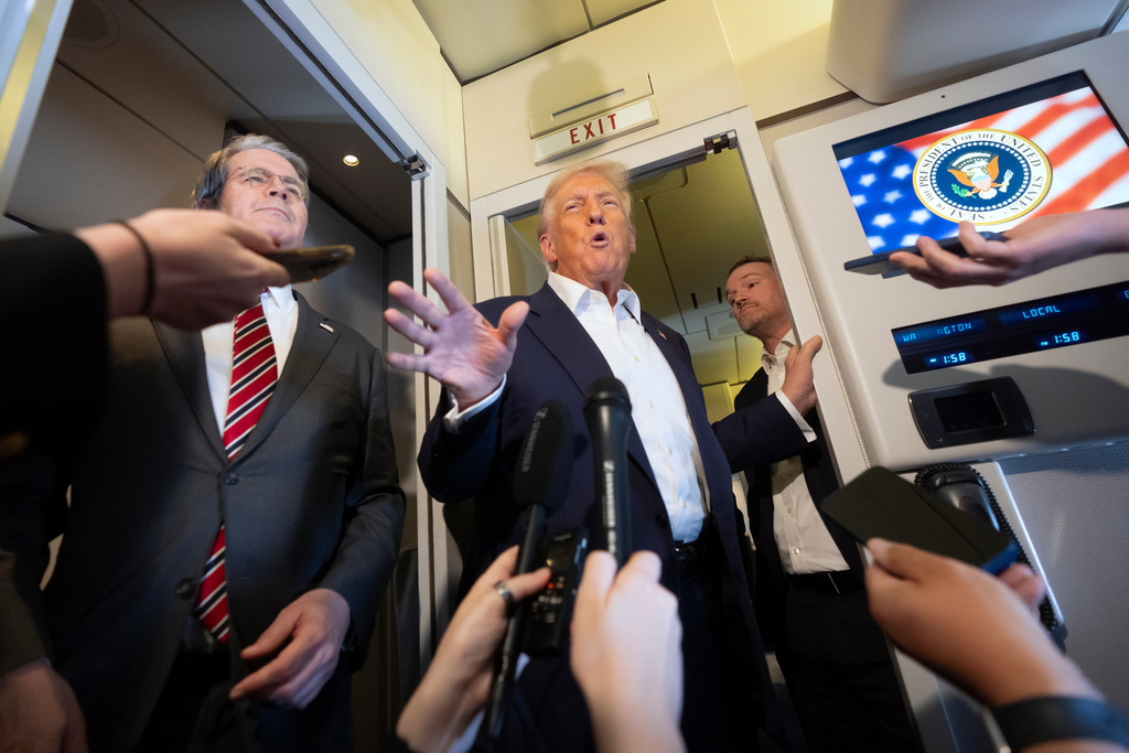 President Donald Trump, center, joined by Treasury Secretary Scott Bessent, left, and U.S. Trade Representative Jamieson Greer, right, speaks to reporters aboard Air Force One while traveling from Kuala Lumpur, Malaysia, to Tokyo, Japan, Monday, Oct. 27, 2025. 