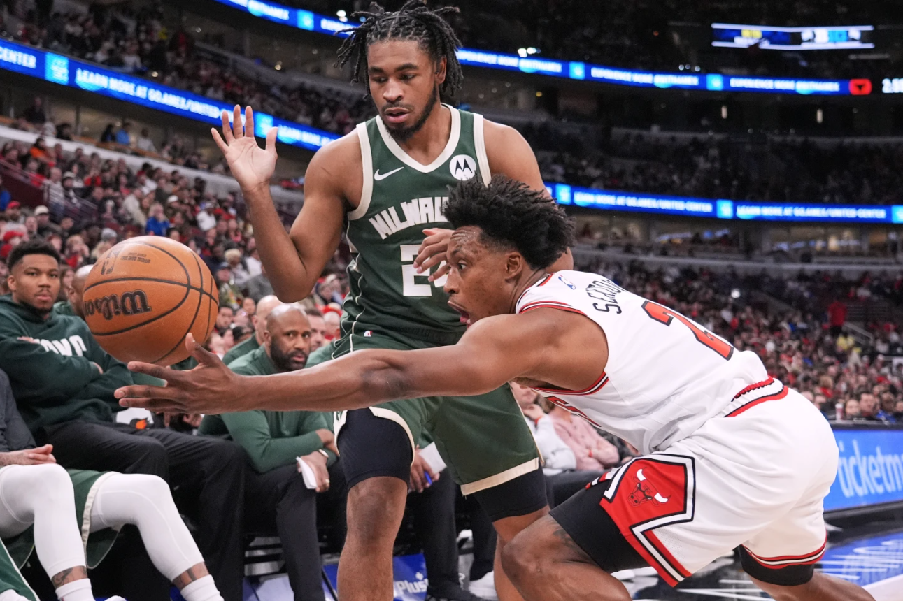 Chicago Bulls guard Colin Sexton, right, steals the ball from Milwaukee Bucks guard Cam Thomas, top, during the first half of an NBA basketball game in Chicago, Sunday, March 1, 2026.