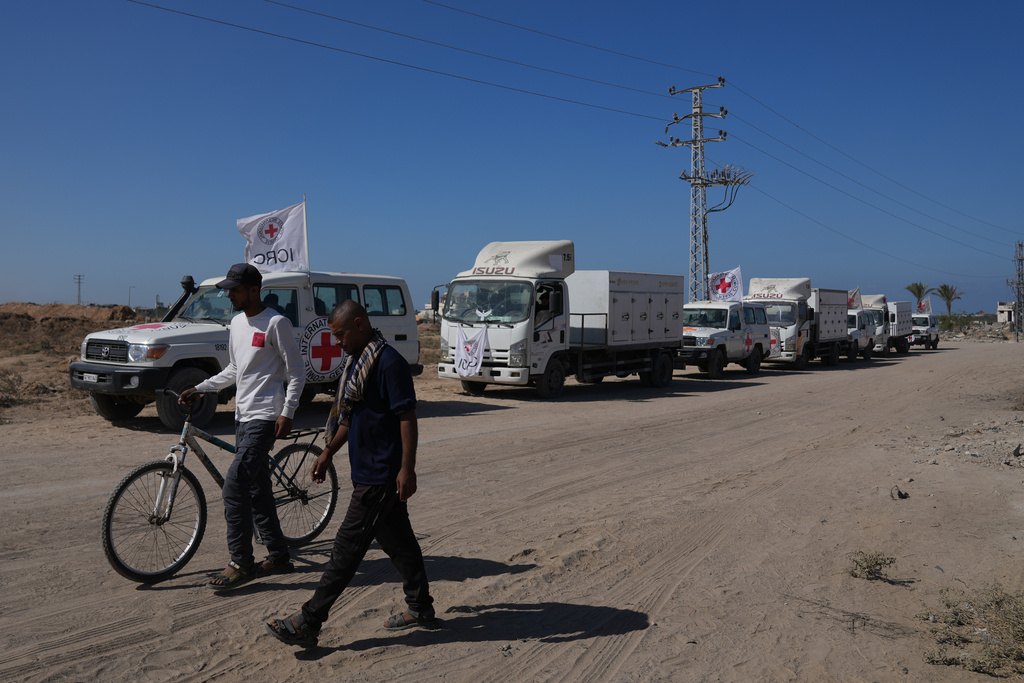 A convoy of Red Cross vehicles transports the bodies of deceased Palestinians held by Israel during the war, after their release, in Deir al-Balah, Gaza, Wednesday, Oct. 15, 2025. 