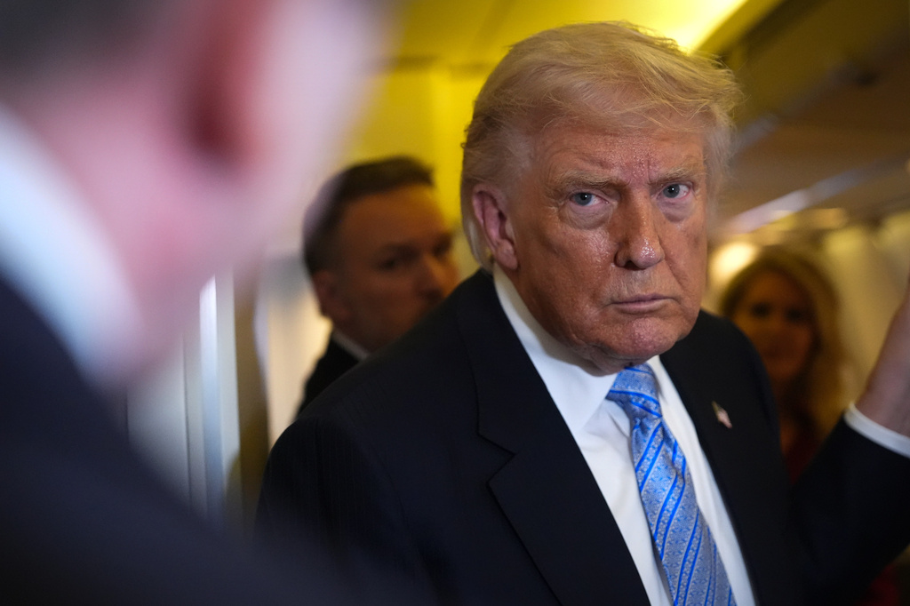 President Donald Trump speaks to reporters aboard Air Force One, Friday, May 15, 2026, as he returns from a trip to Beijing, China. 