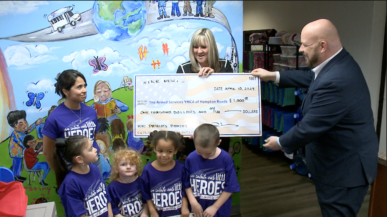 News 3 anchor Blaine Stewart presents a donation check of $1,000 to the Armed Services YMCA in Virginia Beach