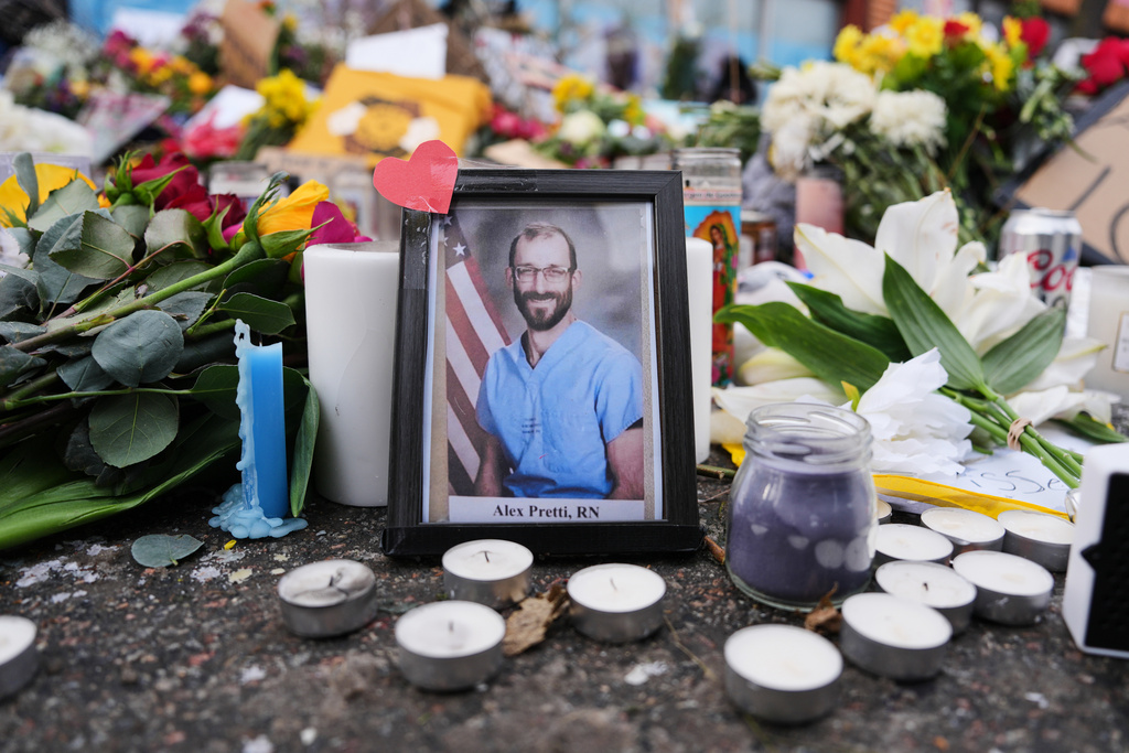 A photo of 37-year-old Alex Pretti, who was fatally shot by a U.S. Border Patrol officer over the weekend, is displayed at the shooting scene Monday, Jan. 26, 2026, in Minneapolis.