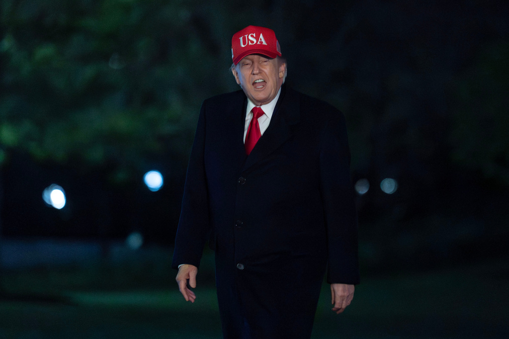 President Donald Trump talks to reporters as he walks on the South Lawn upon his arrival to the White House, Sunday, April 12, 2026, in Washington. 