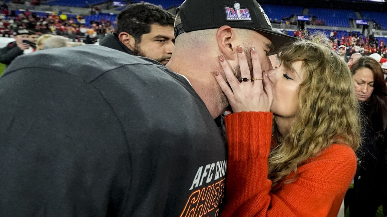 Taylor Swift kisses Kansas City Chiefs tight end Travis Kelce.
