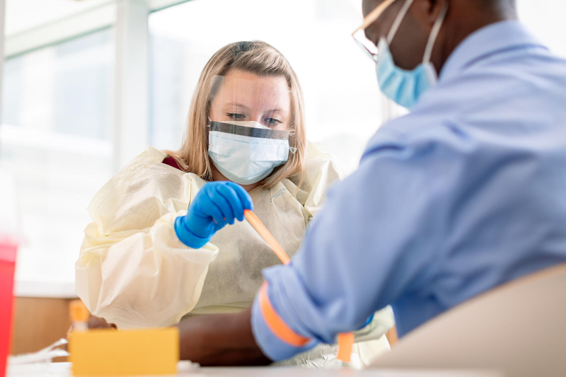 Nurse applies tourniquet to a patient for blood draw