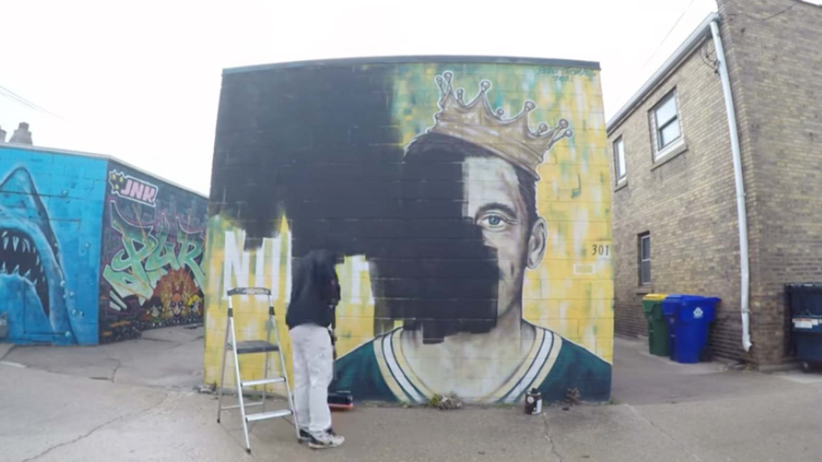 Artist Beau Thomas paints over Rodgers mural 