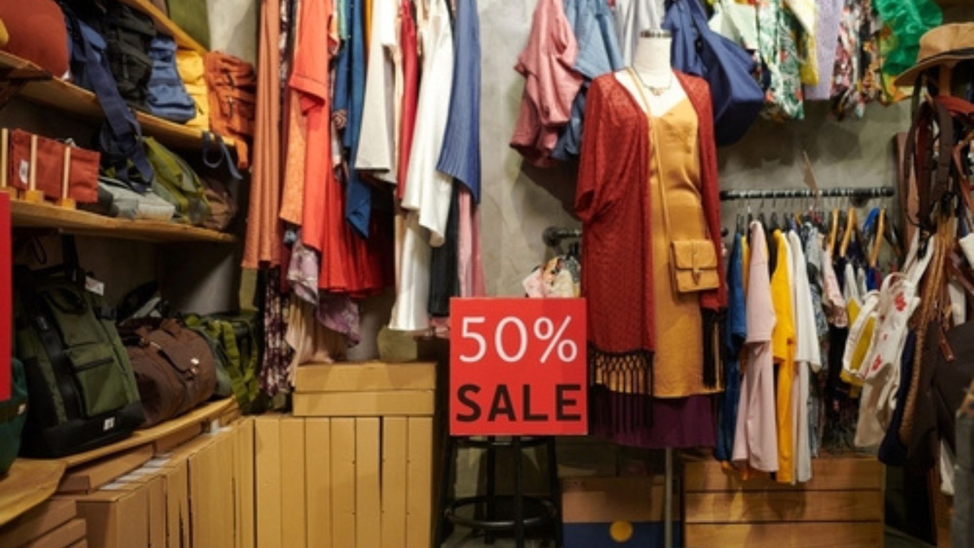Stock image of a 50% off sign inside a thrift store.