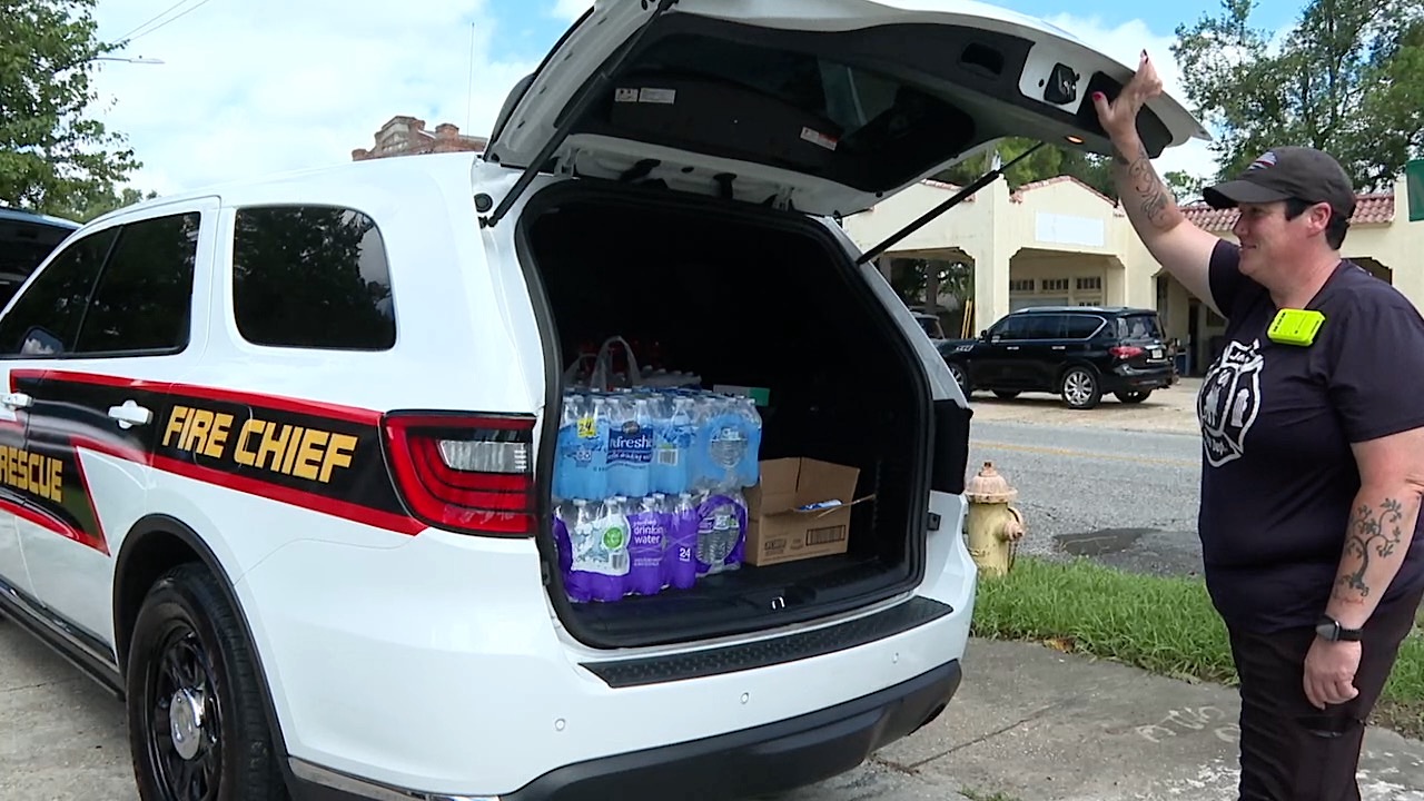 Jeanerette Fire Chief, Sherry Landry, stands with one of the several loaded vehicles taken to Houma.