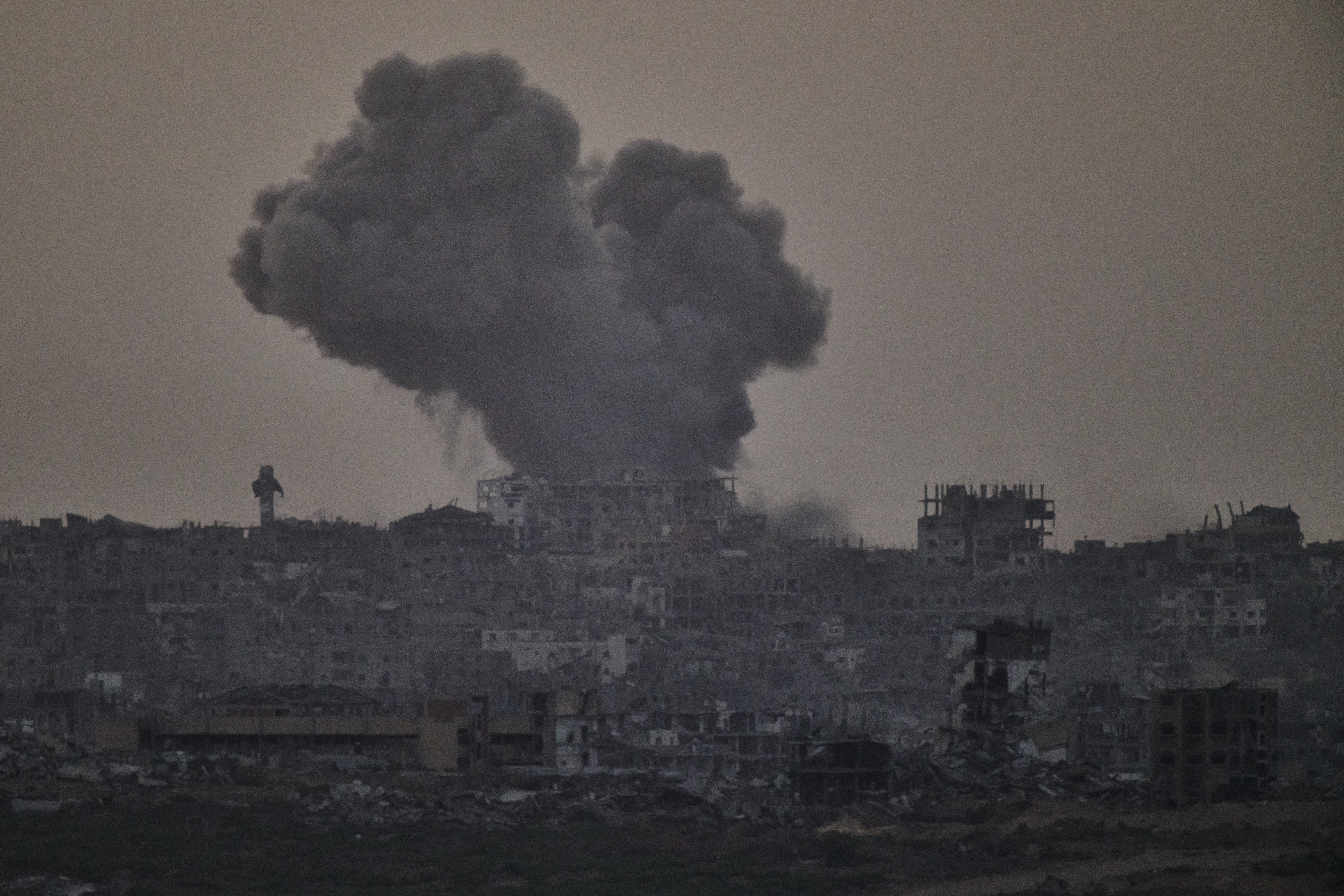 Smoke rises amid buildings, that were destroyed during the Israeli ground and air operations, following an Israeli military strike in the northern Gaza Strip, as seen from southern Israel, Friday, Oct. 3, 2025. 