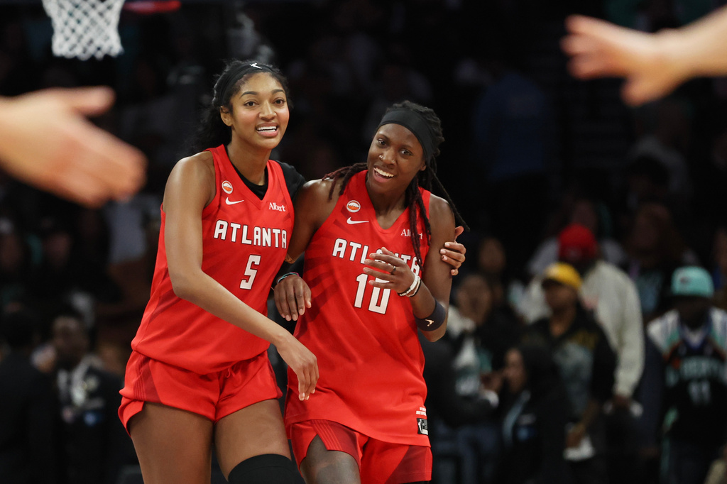 Atlanta Dream forward Angel Reese (5) and Atlanta Dream guard Rhyne Howard (10) react after their team defeated the New York Liberty in Game 3 of the WNBA basketball semifinals, Friday, Oct. 9, 2026, in New York. 