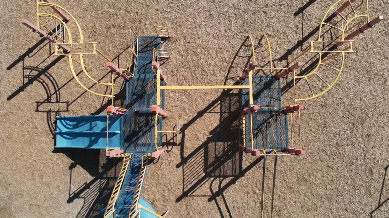 Empty playground equipment at a school in the summer time