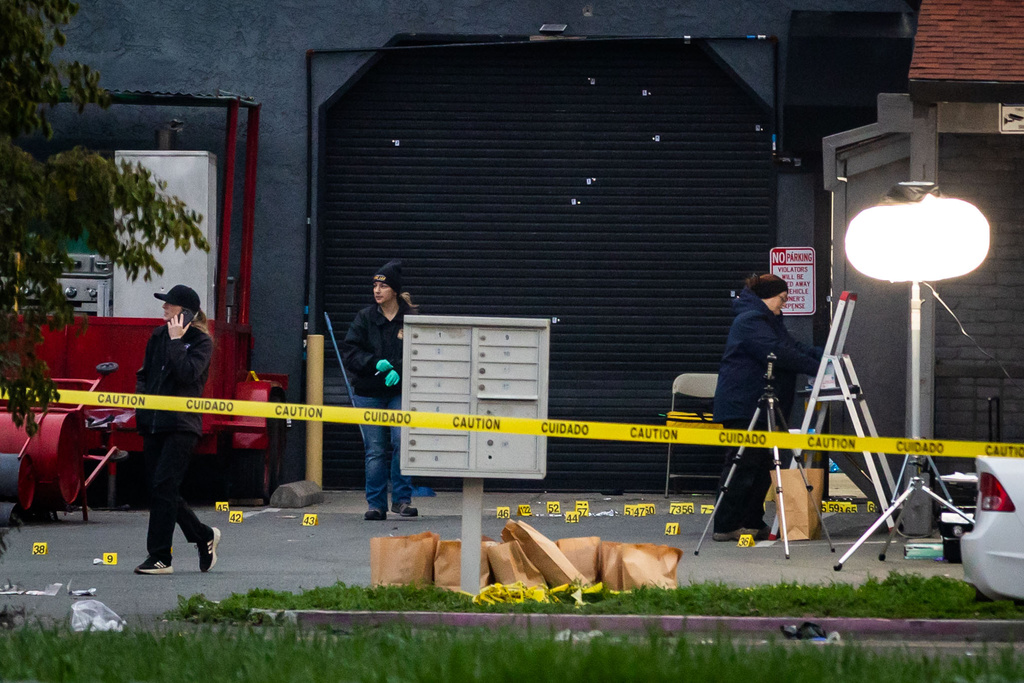 Investigators examine the scene of a mass shooting Sunday, Nov. 30, 2025, in Stockton, Calif. 