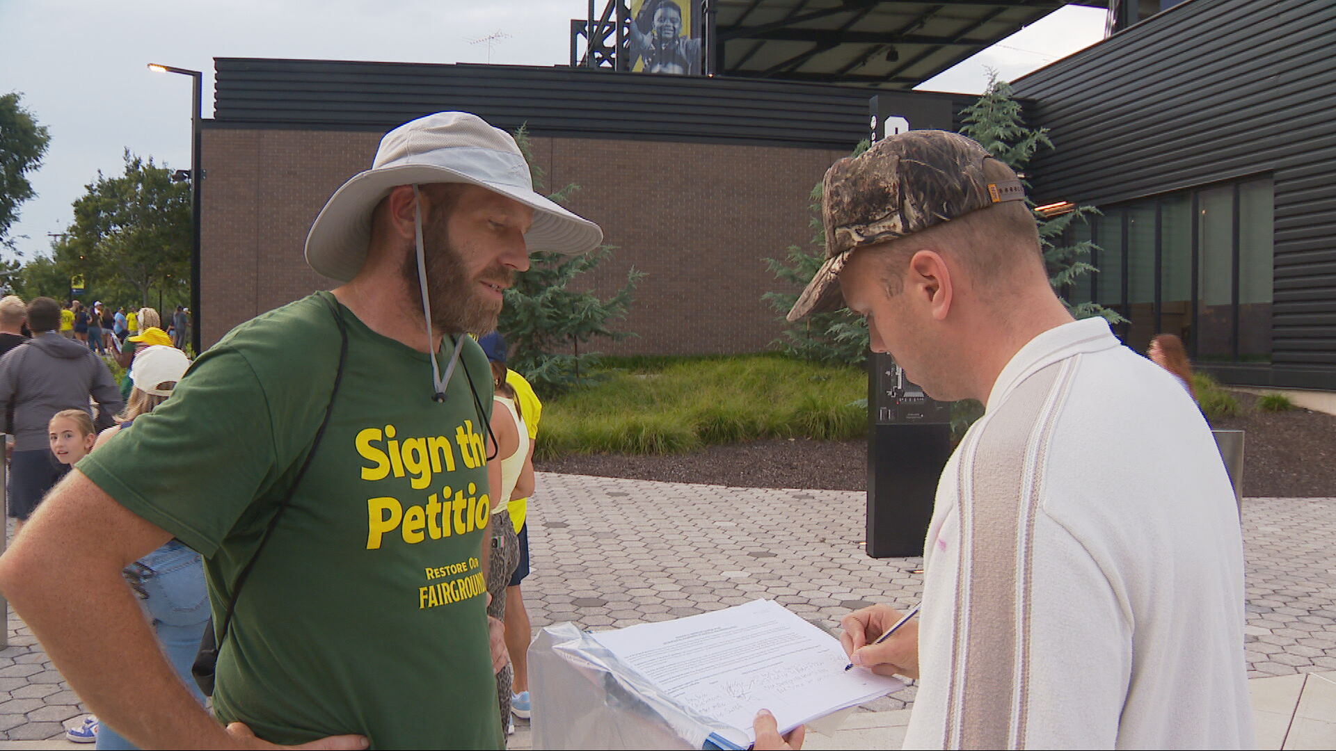 Petition canvassers request signatures outside Geodis Park.