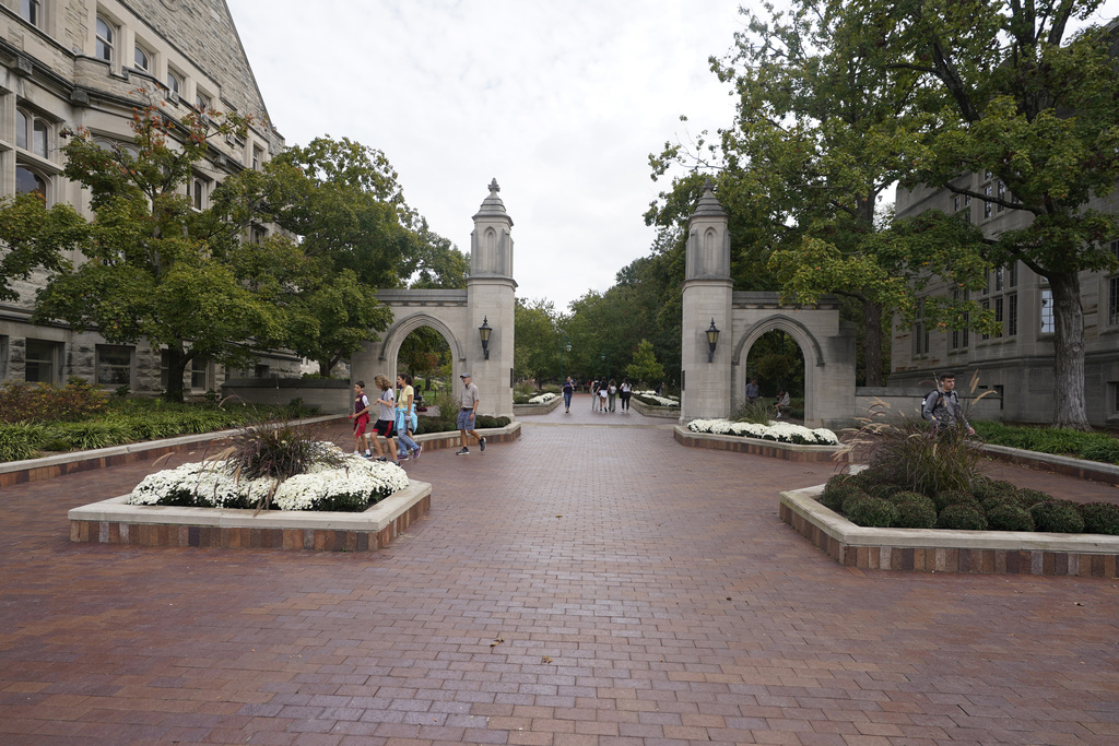 Students walk to class on the Indiana University campus, Oct. 14, 2021, in Bloomington, Ind. 