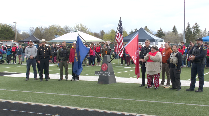 Flathead County law enforcement and Special Olympic athletes gather around ceremonial torch, Friday April, 24, 2026