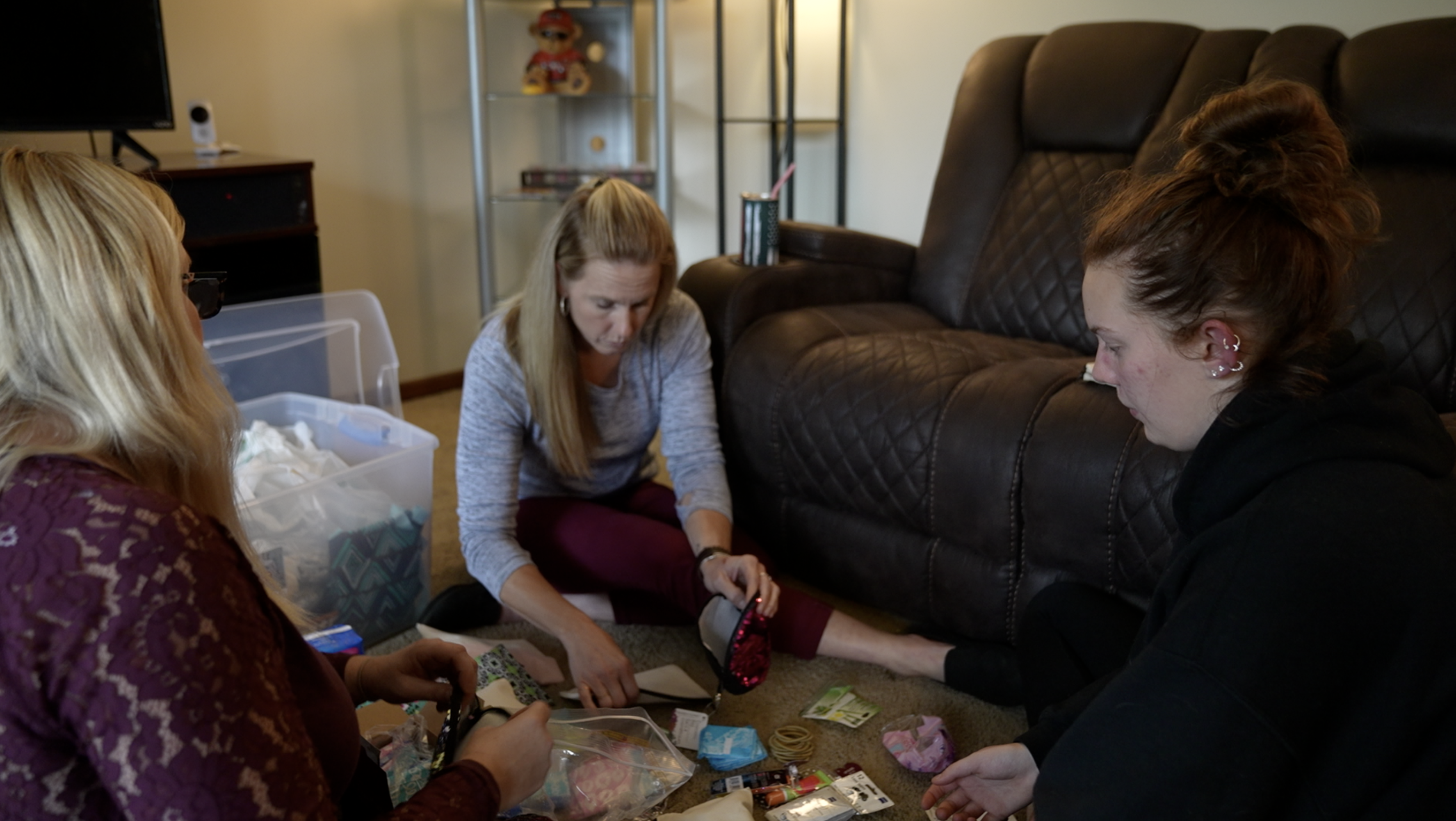 Payton Keck, Melisa Keck and Tina Curtis are putting the kits together.